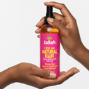 Spray après-shampoing tenu en main